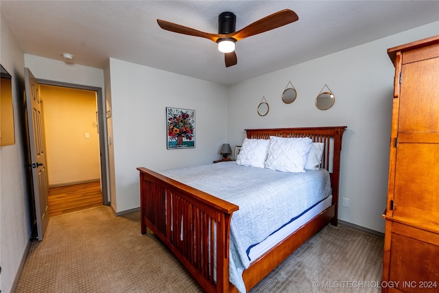 carpeted bedroom with ceiling fan