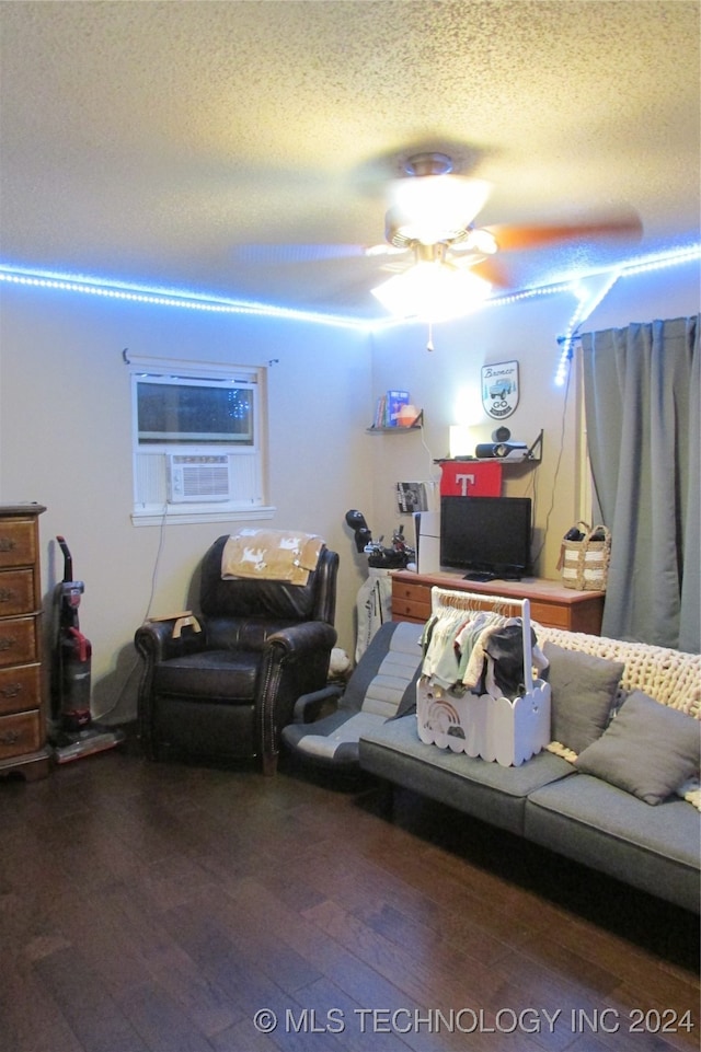 living room featuring a textured ceiling, dark hardwood / wood-style floors, cooling unit, and ceiling fan