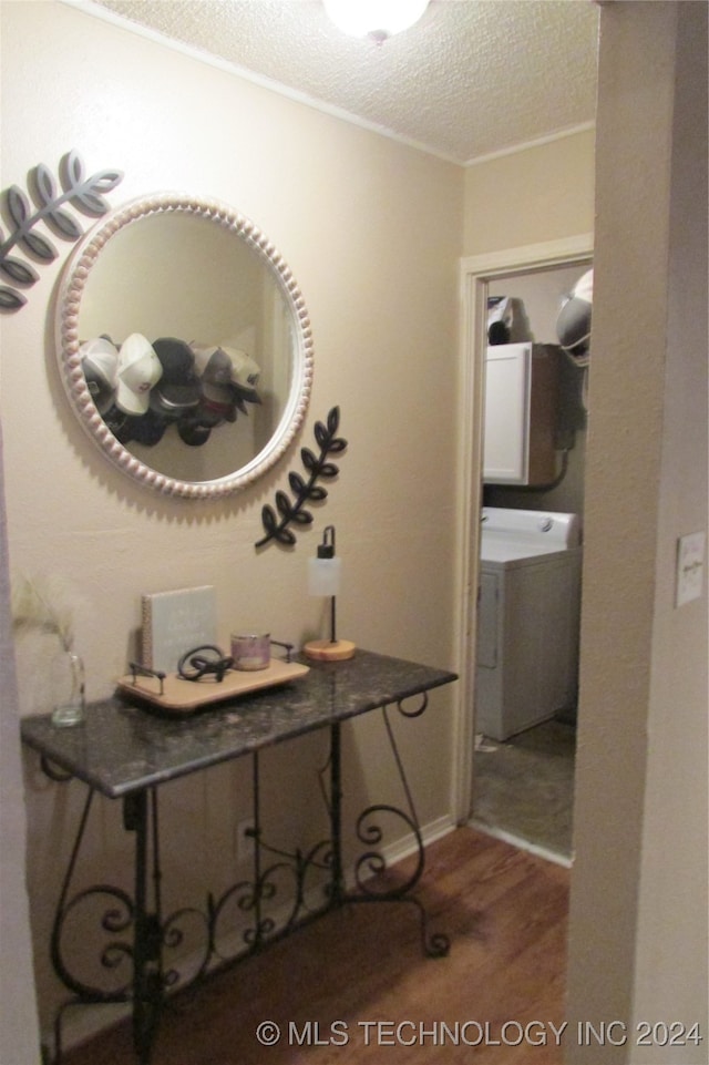 interior space with washer / clothes dryer, hardwood / wood-style floors, and a textured ceiling