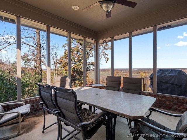 sunroom featuring ceiling fan