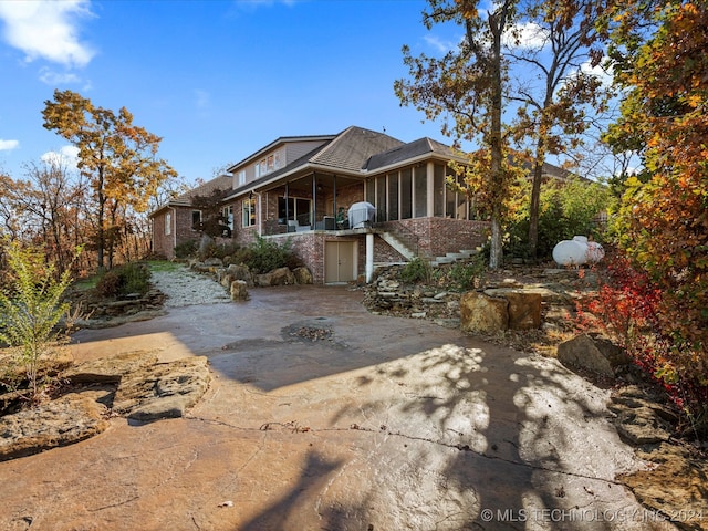 back of house with a patio and a sunroom