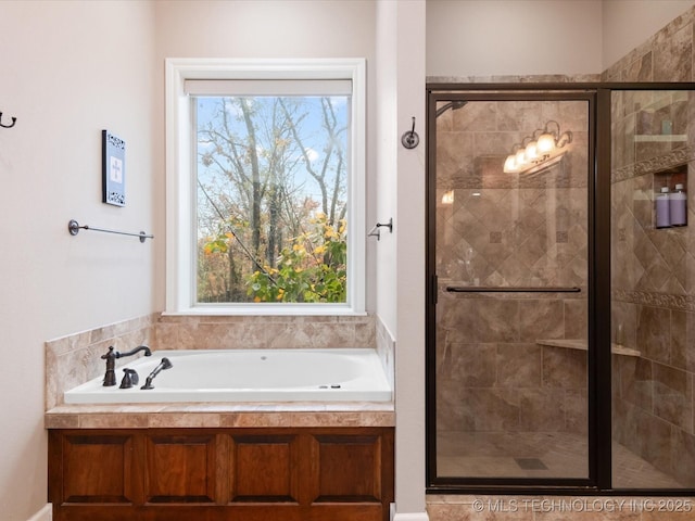 bathroom featuring separate shower and tub