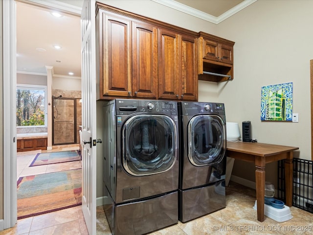 laundry area featuring washer and dryer, light tile patterned floors, crown molding, and cabinets