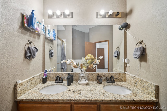 bathroom featuring vanity and a shower with shower door