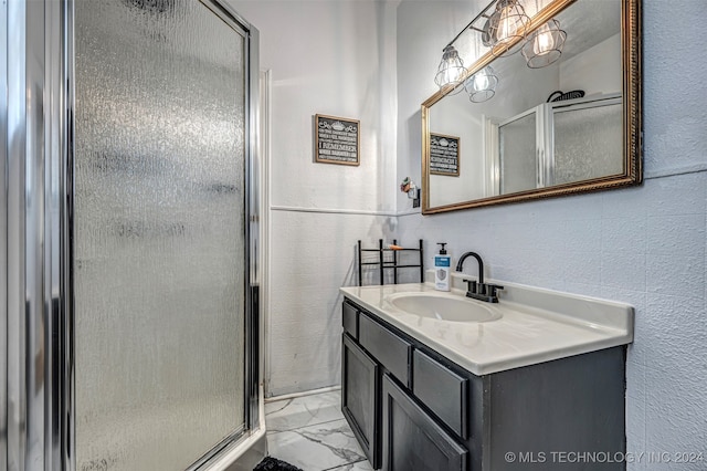 bathroom featuring vanity and a shower with door