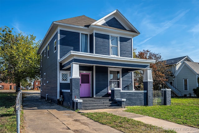 view of front of property with a porch and a front yard