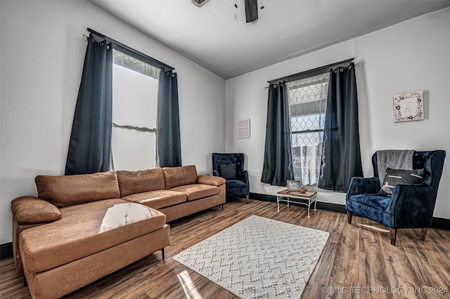 living room featuring ceiling fan and hardwood / wood-style floors