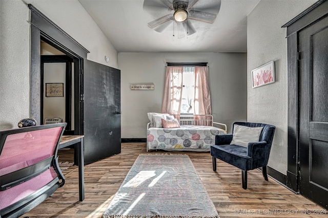 living area with hardwood / wood-style flooring and ceiling fan