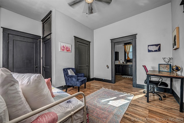 living room featuring wood-type flooring and ceiling fan