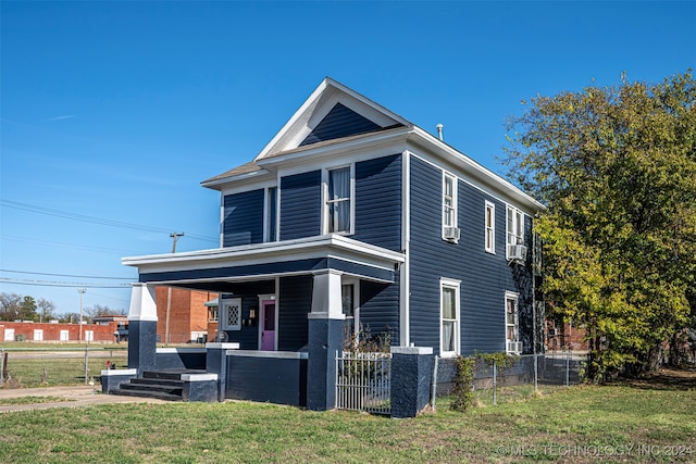 view of front of house with cooling unit, a porch, and a front yard