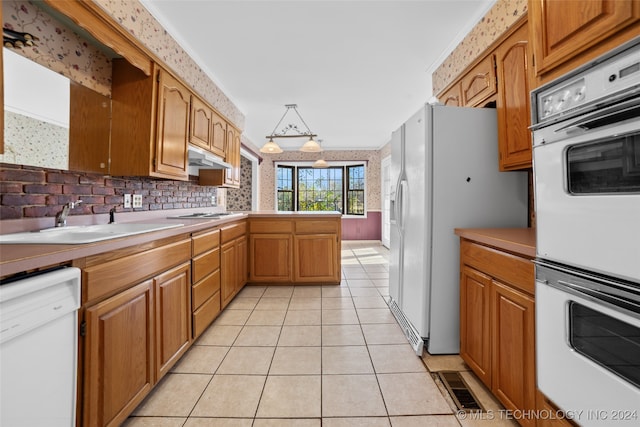 kitchen featuring light tile patterned flooring, white appliances, sink, and ornamental molding