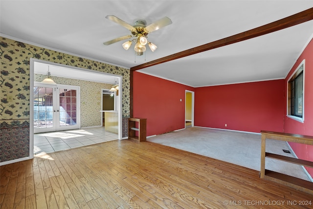 empty room featuring ceiling fan, french doors, wood-type flooring, and ornamental molding