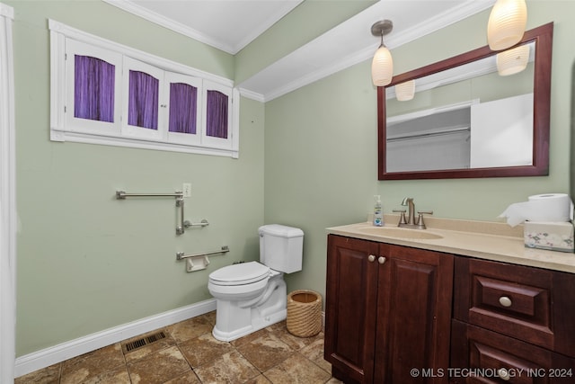 bathroom featuring vanity, toilet, and ornamental molding