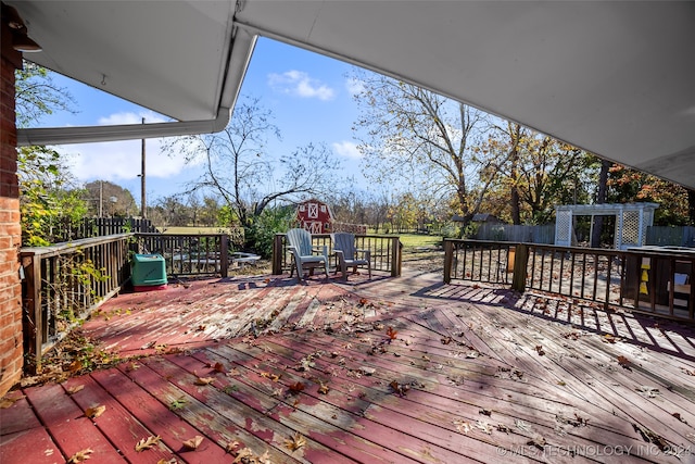 wooden deck with an outbuilding