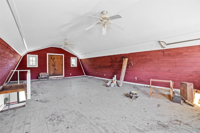 bonus room with hardwood / wood-style flooring, ceiling fan, lofted ceiling, and wood walls