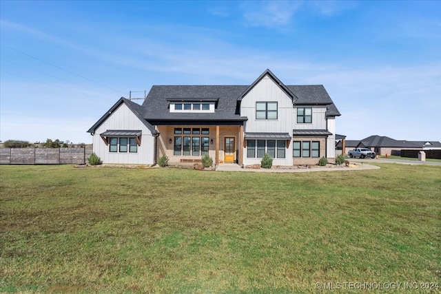 modern farmhouse style home with a front yard