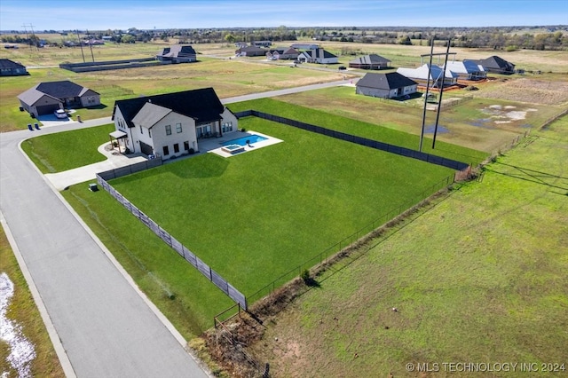 birds eye view of property with a rural view