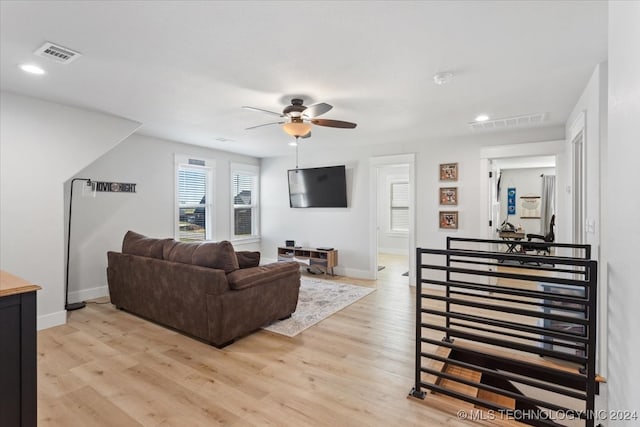 living room with ceiling fan and light hardwood / wood-style floors