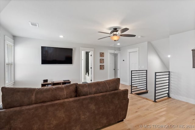 living room with ceiling fan and light wood-type flooring