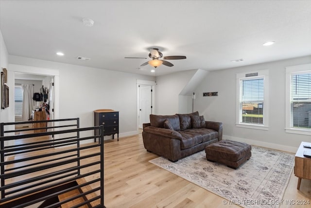 living room featuring ceiling fan and light wood-type flooring