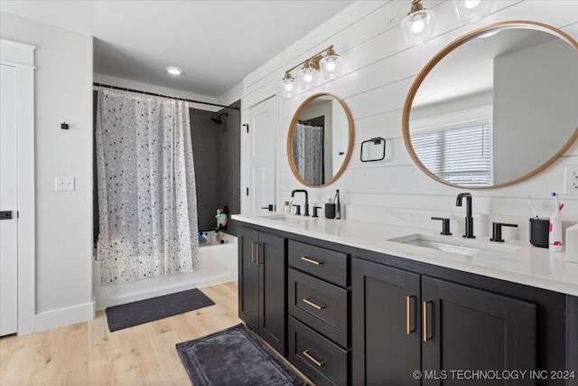 bathroom featuring hardwood / wood-style flooring, vanity, and shower / bathtub combination with curtain