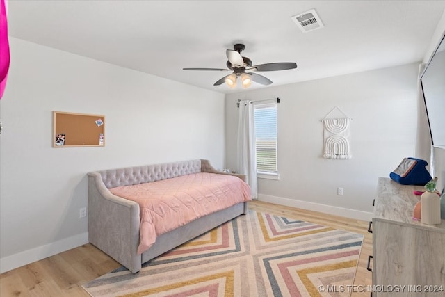 bedroom with ceiling fan and light hardwood / wood-style flooring