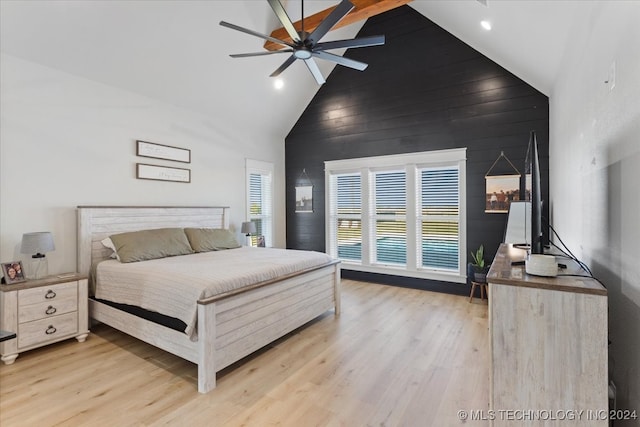 bedroom with ceiling fan, high vaulted ceiling, and light hardwood / wood-style flooring