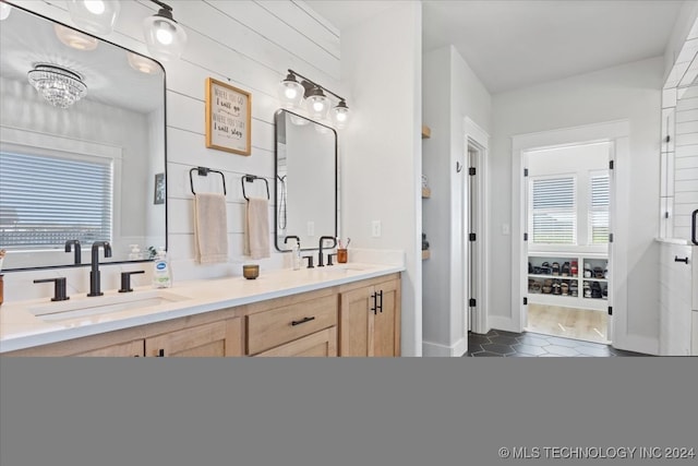 bathroom with a chandelier, vanity, hardwood / wood-style flooring, and a wealth of natural light