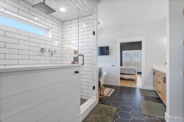 bathroom with vanity, a healthy amount of sunlight, and a shower