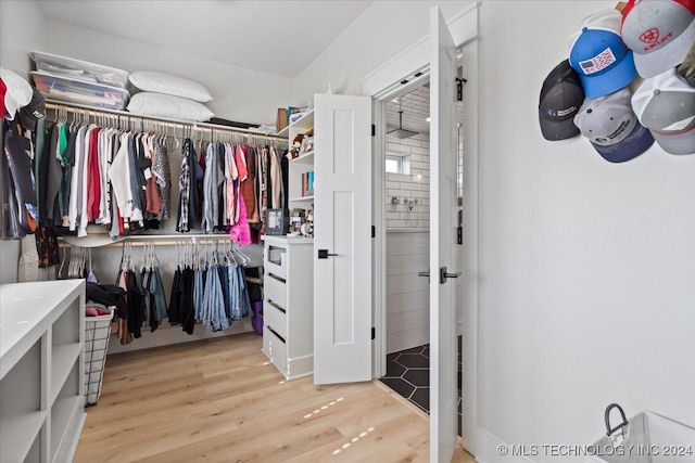 spacious closet with light hardwood / wood-style flooring