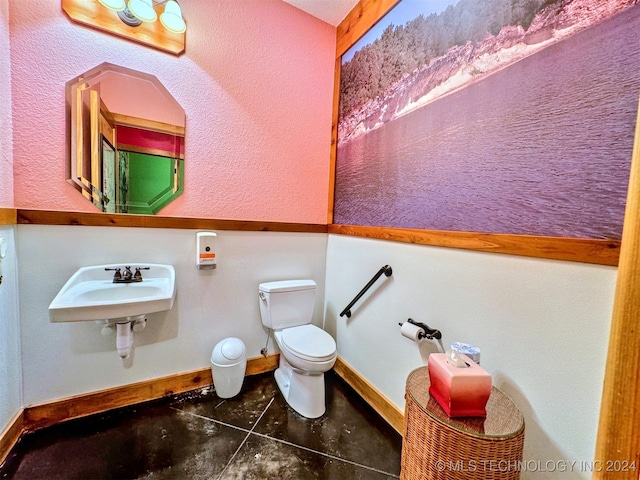 bathroom with tile patterned flooring, toilet, and sink