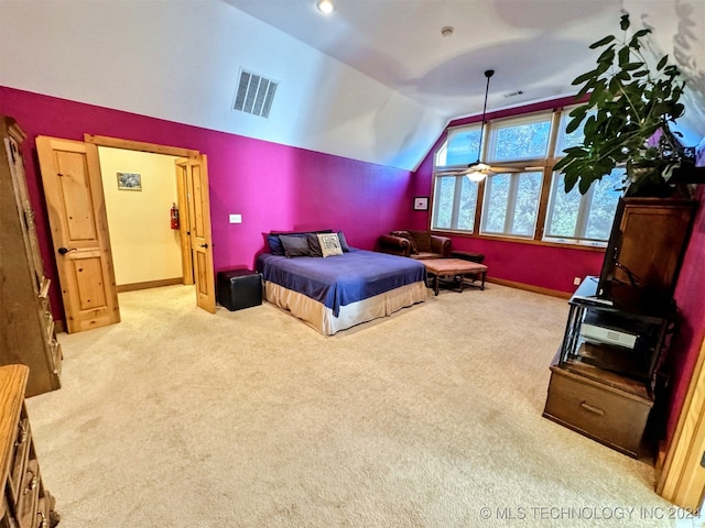 bedroom featuring light carpet and lofted ceiling