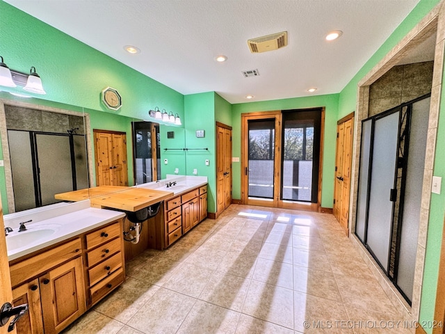 bathroom with vanity, french doors, tile patterned floors, a textured ceiling, and an enclosed shower