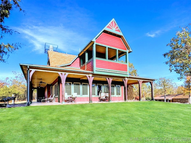 back of house with a lawn, ceiling fan, and a patio area