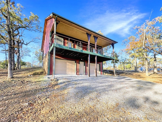 view of front facade with a balcony and a garage