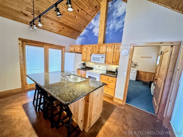 kitchen featuring white appliances, high vaulted ceiling, a center island with sink, sink, and a breakfast bar area