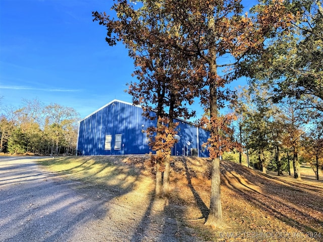 view of side of home with an outbuilding