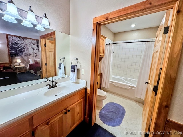 full bathroom featuring shower / bath combo with shower curtain, vanity, and toilet