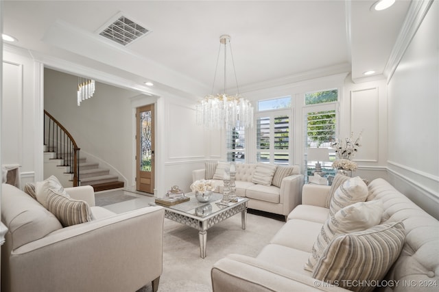 living room featuring crown molding and a chandelier