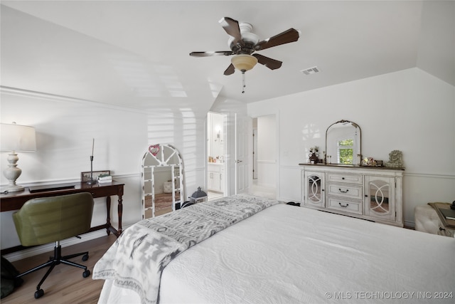 bedroom with ceiling fan, ensuite bathroom, lofted ceiling, and wood-type flooring