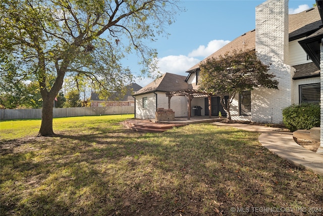 view of yard with a pergola and a patio