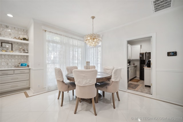 tiled dining area featuring a chandelier and crown molding