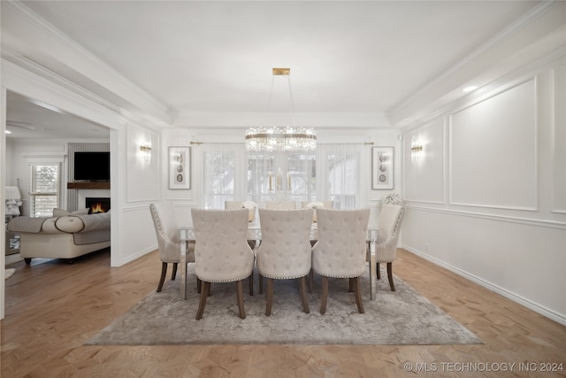 dining room featuring hardwood / wood-style floors, a chandelier, and ornamental molding