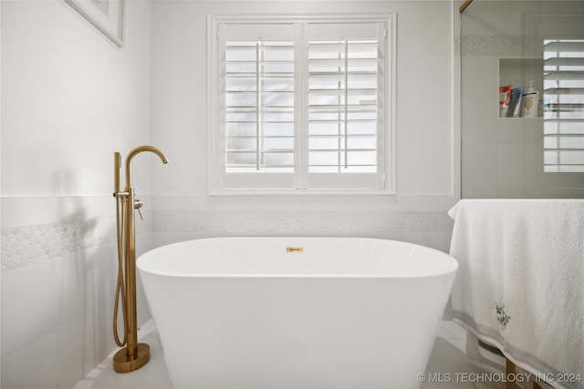 bathroom featuring a tub to relax in