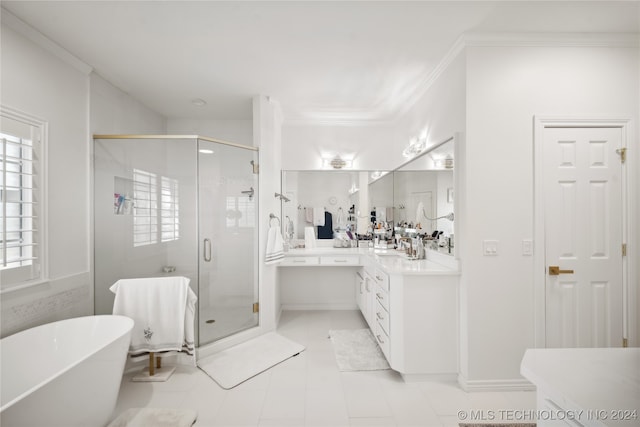 bathroom with tile patterned floors, vanity, separate shower and tub, and crown molding