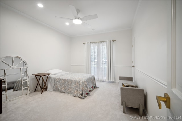 carpeted bedroom with ceiling fan and ornamental molding