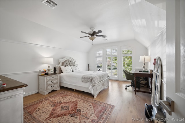 bedroom with ceiling fan, access to exterior, light hardwood / wood-style flooring, and vaulted ceiling