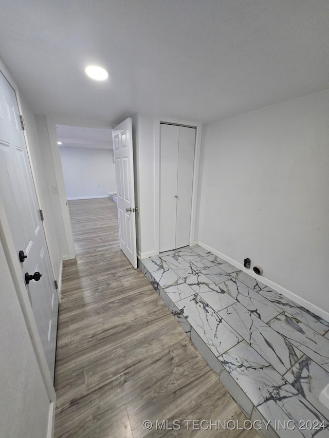 corridor with light hardwood / wood-style floors