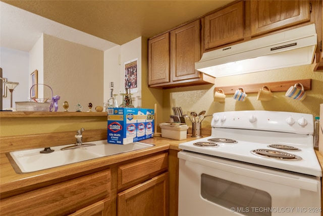 kitchen with white range with electric cooktop and sink