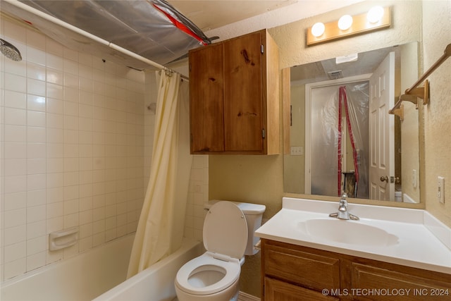 full bathroom featuring shower / bath combo, vanity, a textured ceiling, and toilet